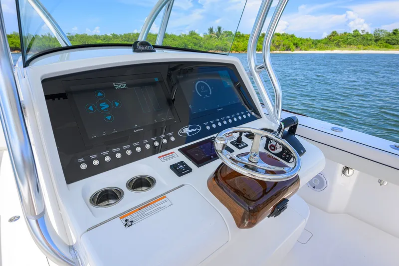 Slide: The Image of 2025 Valhalla Boatworks V-33 helm with advanced navigation system and steering wheel. - 19