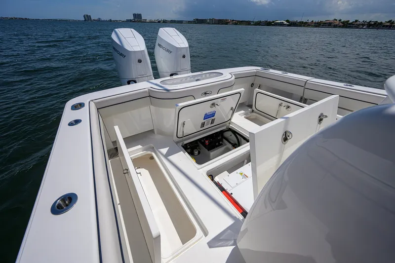 Slide: The Image of 2025 Valhalla Boatworks V-33 with open storage compartments and twin Mercury engines. - 59