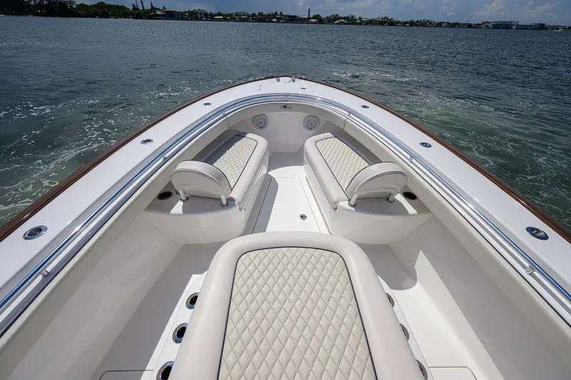 Slide: The Image of 2025 Valhalla Boatworks V-33 interior with luxurious seating on calm waters. - 32