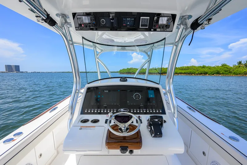 Slide: The Image of 2025 Valhalla Boatworks V-33 helm with advanced navigation system on open water. - 21