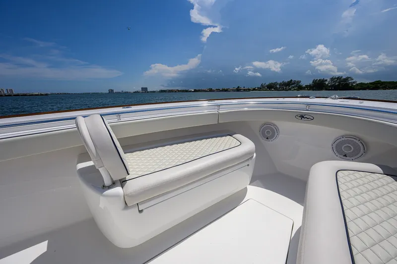 Slide: The Image of 2025 Valhalla Boatworks V-33 interior with white seating, ocean view, and clear sky. - 34
