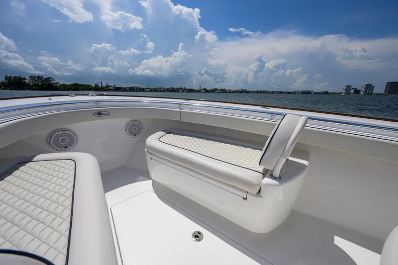 Slide: The Image of 2025 Valhalla Boatworks V-33 interior with cushioned seating and ocean view. - 35