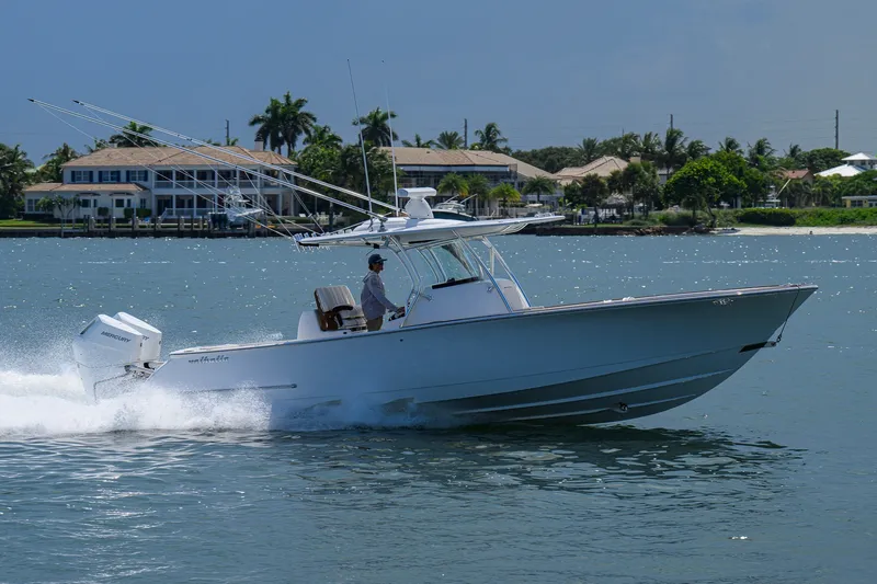 Slide: The Image of 2025 Valhalla Boatworks V-33 cruising on water near coastal homes. - 14
