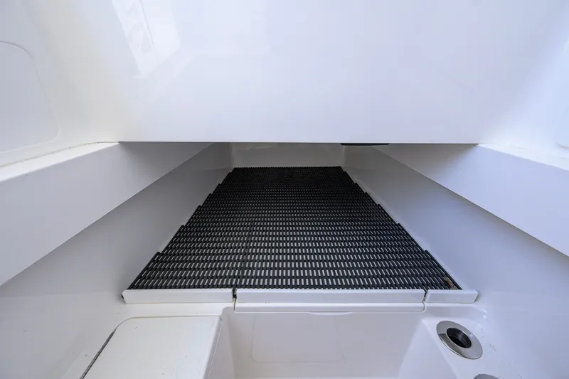 Slide: The Image of 2025 Valhalla Boatworks V-33 interior with sleek white surfaces and black mat flooring. - 73