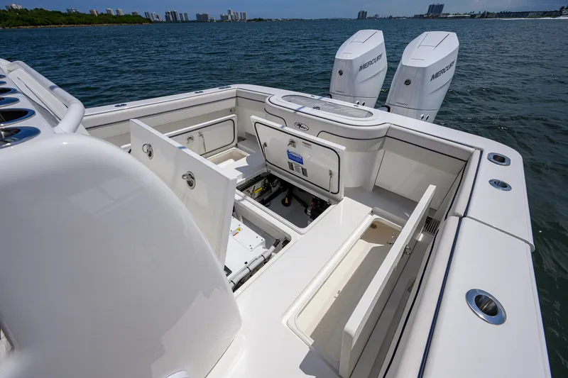 Slide: The Image of 2025 Valhalla Boatworks V-33 with open storage compartments and twin Mercury engines on the water. - 57