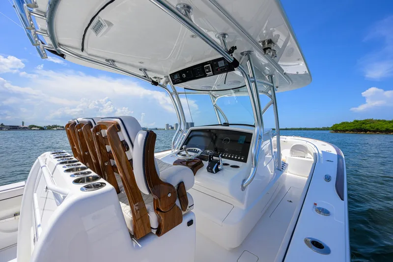 Slide: The Image of 2025 Valhalla Boatworks V-33 center console on open water, showcasing helm and seating. - 25