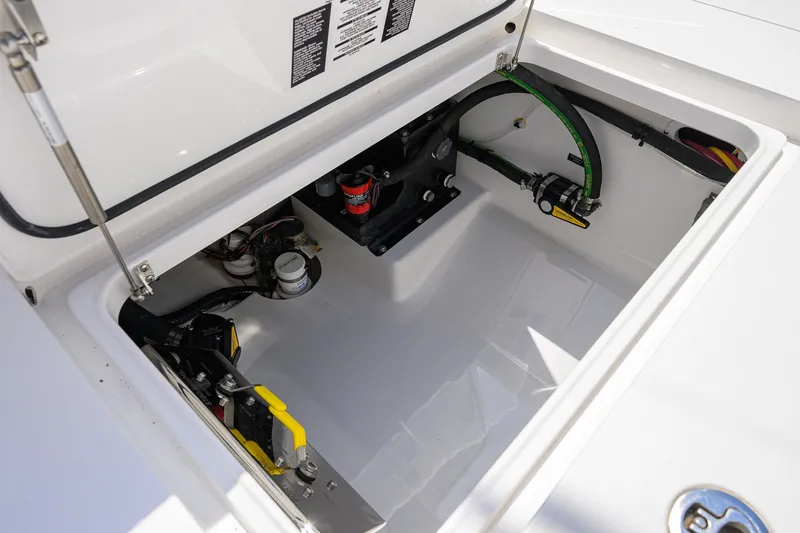 Slide: The Image of Open storage compartment of 2025 Valhalla Boatworks V-33, showcasing internal components and wiring. - 67