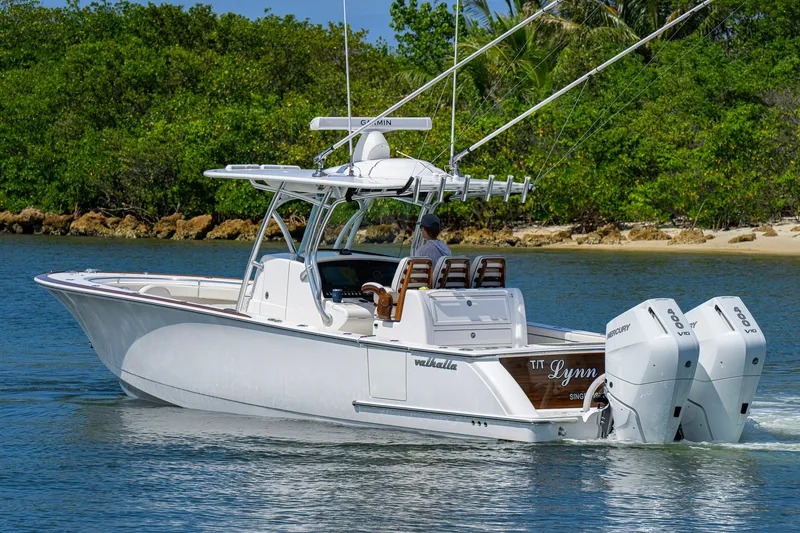 Slide: The Image of 2025 Valhalla Boatworks V-33 cruising on water with twin Mercury engines. - 6