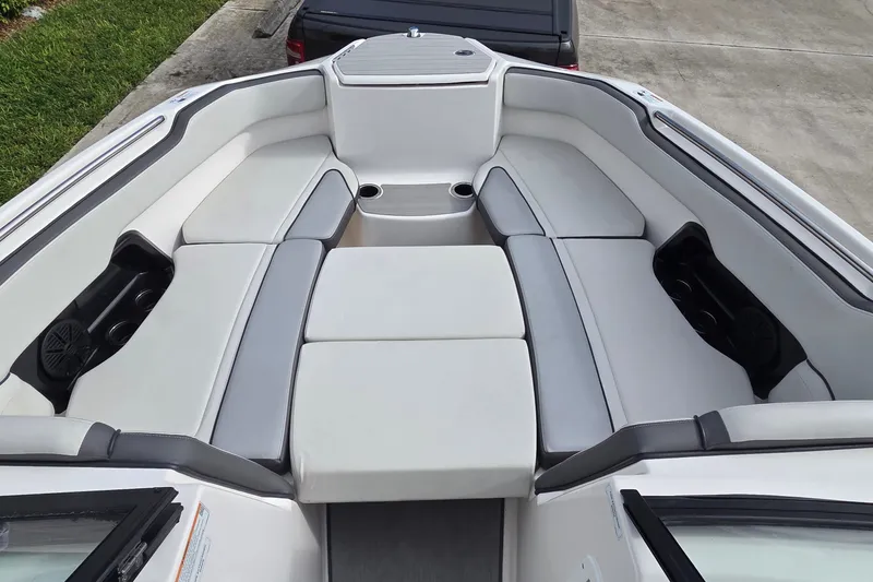 Slide: The Image of 2024 Yamaha Boats SX250 interior with spacious seating and cup holders. - 12