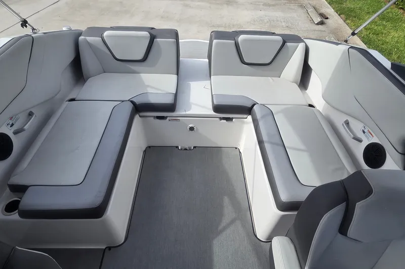 Slide: The Image of 2024 Yamaha Boats SX250 interior seating with gray and black upholstery. - 5
