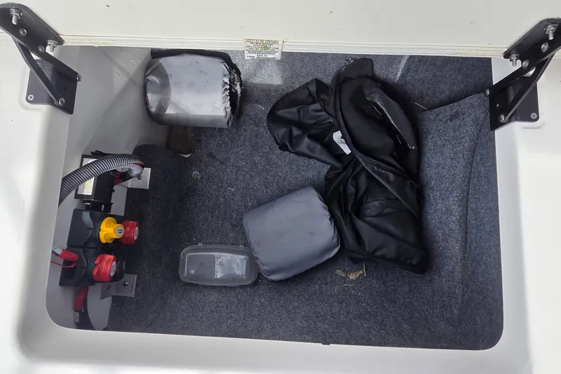Slide: The Image of Storage compartment of 2024 Yamaha Boats SX250 with equipment and accessories. - 11
