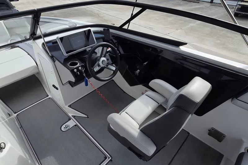 Slide: The Image of 2024 Yamaha Boats SX250 cockpit with steering wheel and modern dashboard. - 15