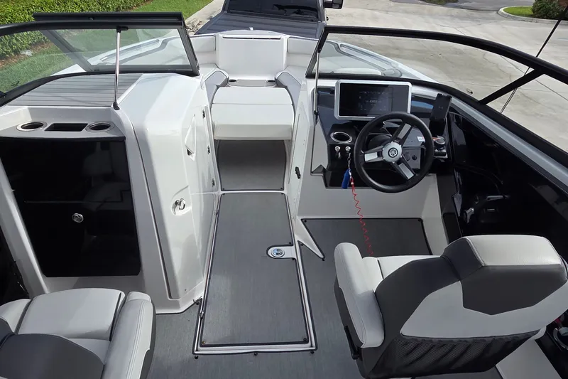 Slide: The Image of 2024 Yamaha Boats SX250 interior with modern helm, seating, and sleek design. - 13