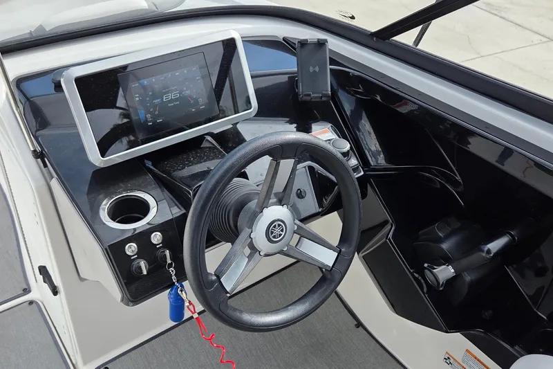 Slide: The Image of 2024 Yamaha Boats SX250 dashboard with steering wheel and digital display. - 8