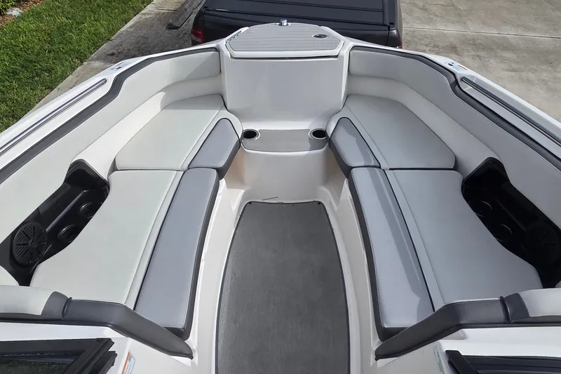 Slide: The Image of 2024 Yamaha Boats SX250 interior with spacious seating and cup holders. - 9