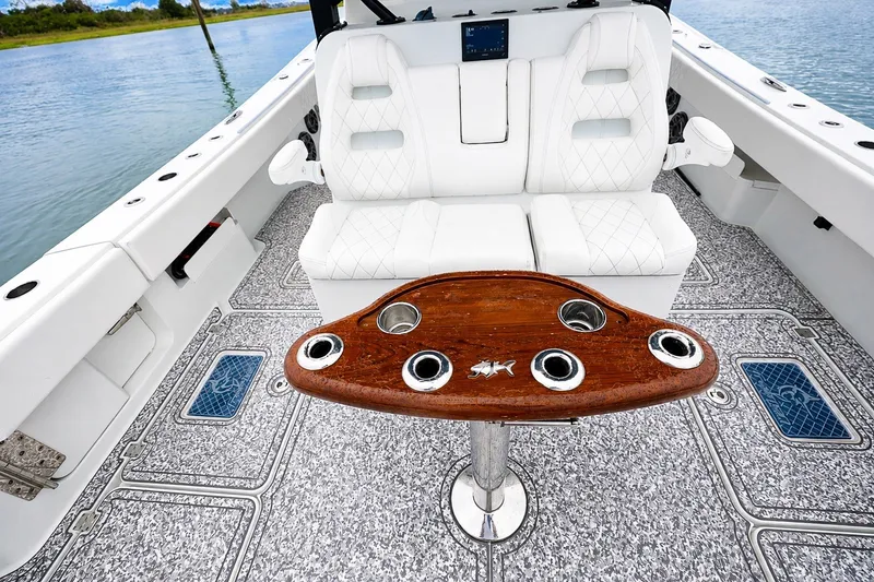 Slide: The Image of Luxurious 2023 Freeman 43 boat interior with white seating and elegant wooden table. - 14
