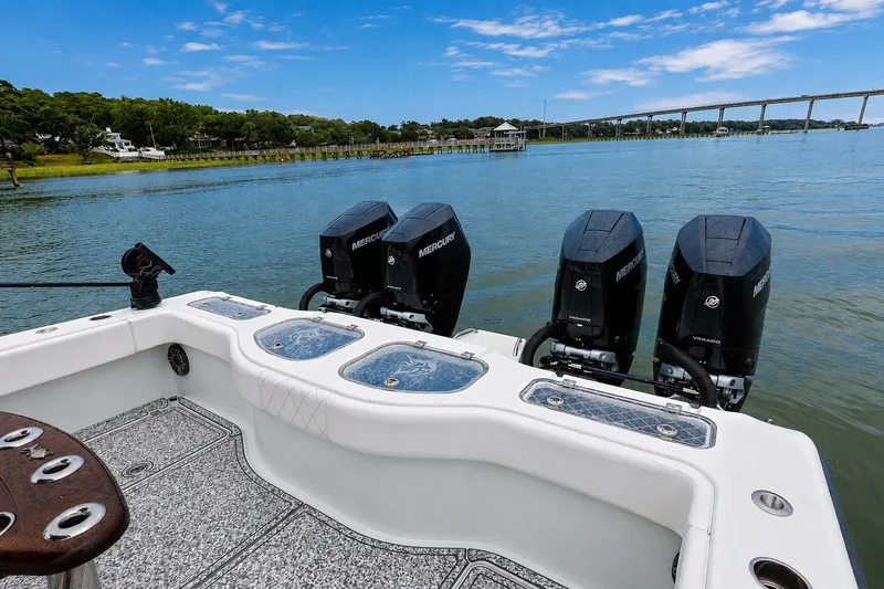 Slide: The Image of Freeman 43 boat with four Mercury engines on a scenic waterway, 2023 model. - 16