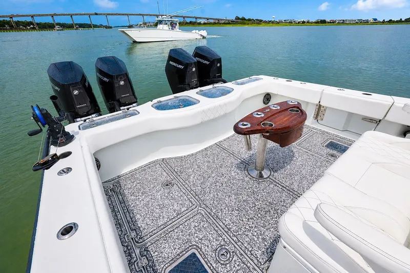 Slide: The Image of Freeman 43 boat interior with Mercury engines, featuring a fishing setup and scenic waterway view. - 13