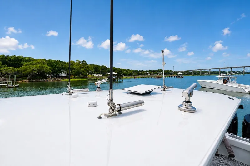 Slide: The Image of Freeman 43 boat on serene water with lush greenery and blue sky, 2023 model. - 18