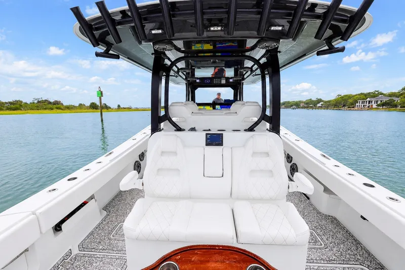 Slide: The Image of Luxury Freeman 43 boat interior, 2023 model, featuring plush seating and modern design on calm waters. - 15