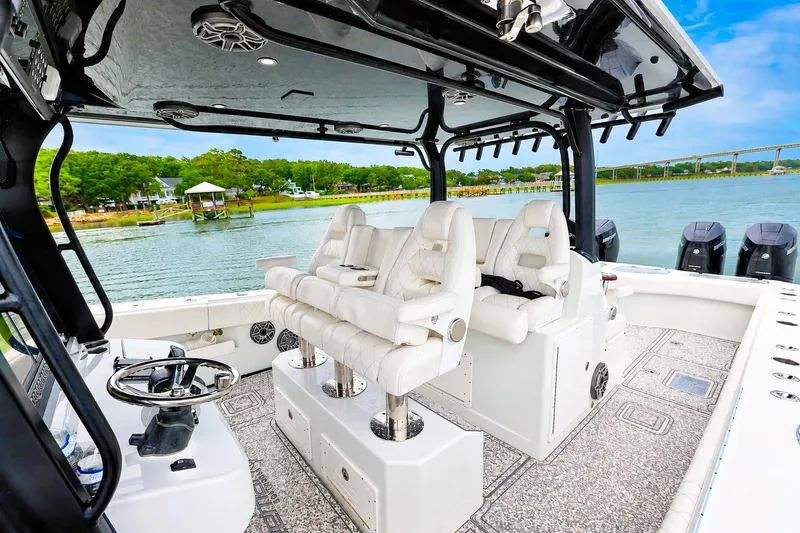 Slide: The Image of Luxurious 2023 Freeman 43 boat interior with plush seating and scenic waterfront view. - 7