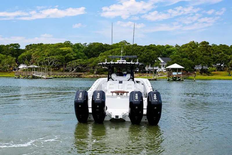 Slide: The Image of 2023 Freeman 43 boat with quad 400 V10 engines on a scenic waterway. - 5