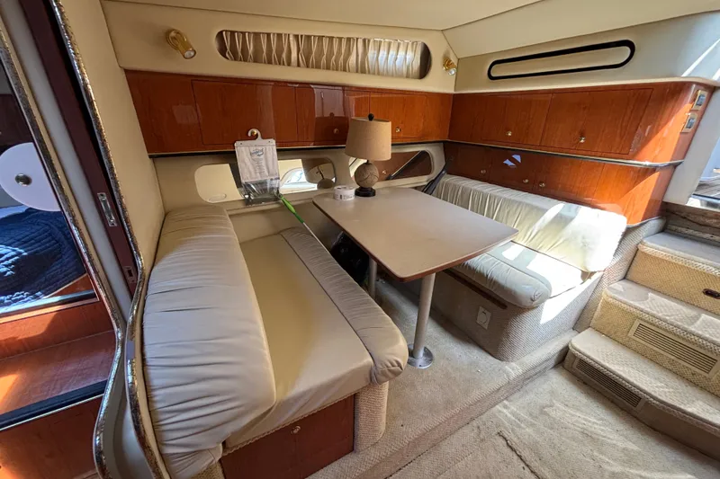 Slide: The Image of Interior of 2001 Sea Ray 340 Amberjack with cozy seating and wooden cabinetry. - 10