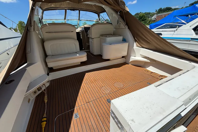 Slide: The Image of 2001 Sea Ray 340 Amberjack boat interior with seating and wooden deck. - 2