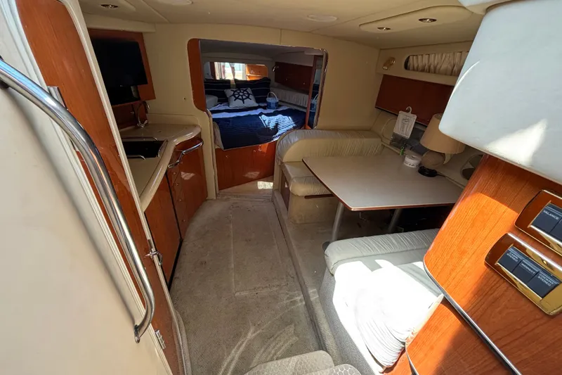 Slide: The Image of Interior of 2001 Sea Ray 340 Amberjack boat with kitchen, seating, and sleeping area. - 9