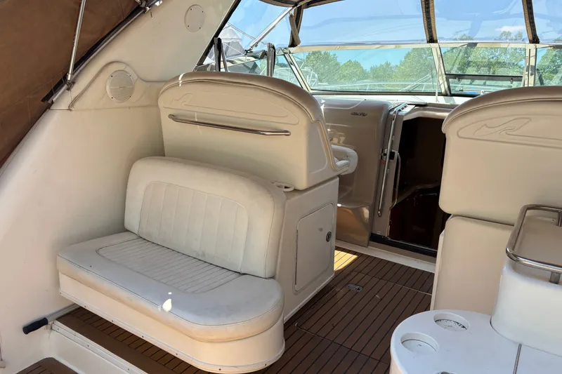 Slide: The Image of 2001 Sea Ray 340 Amberjack boat interior with white seating and wood flooring. - 5