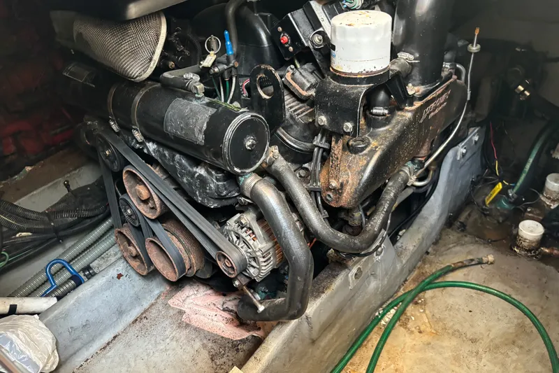 Slide: The Image of Engine compartment of a 2001 Sea Ray 340 Amberjack boat, showing mechanical components and belts. - 14