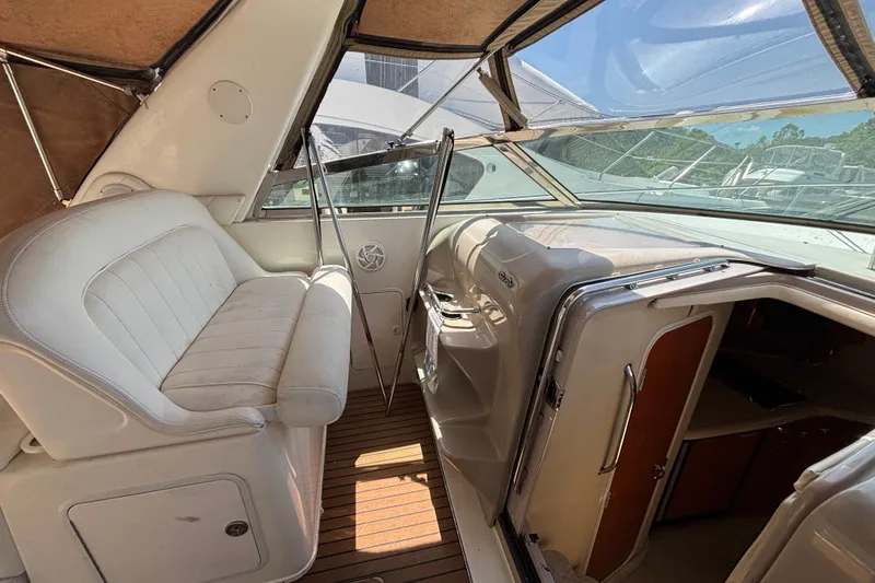 Slide: The Image of Interior view of 2001 Sea Ray 340 Amberjack boat with white seating and wooden flooring. - 6