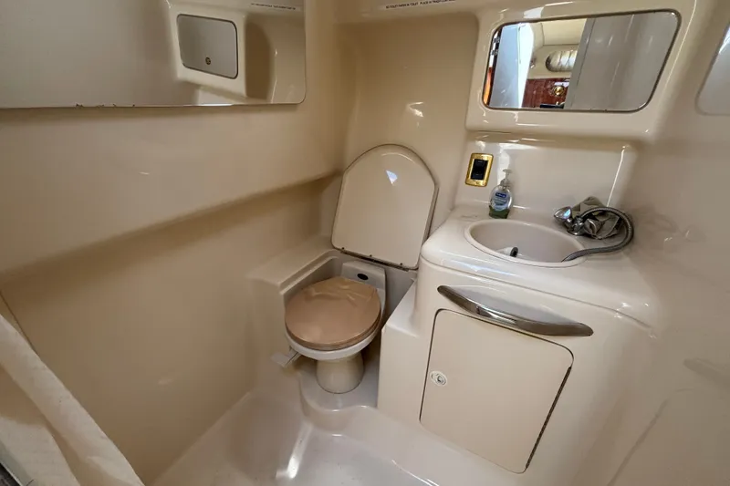 Slide: The Image of 2001 Sea Ray 340 Amberjack bathroom with toilet, sink, and mirror. - 13
