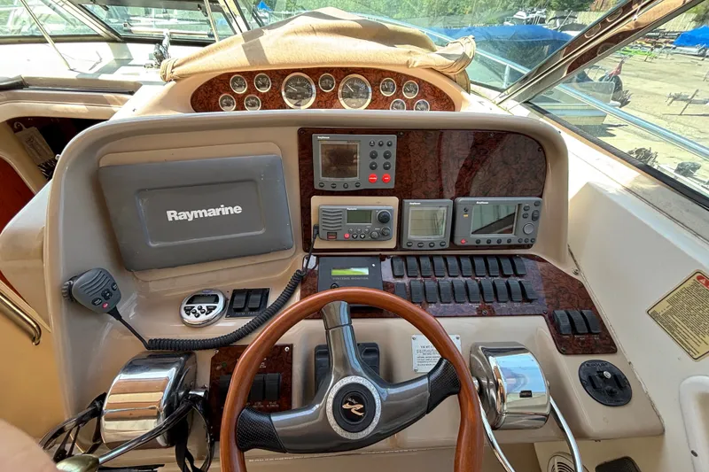 Slide: The Image of Helm of 2001 Sea Ray 340 Amberjack with Raymarine navigation equipment and wooden steering wheel. - 8