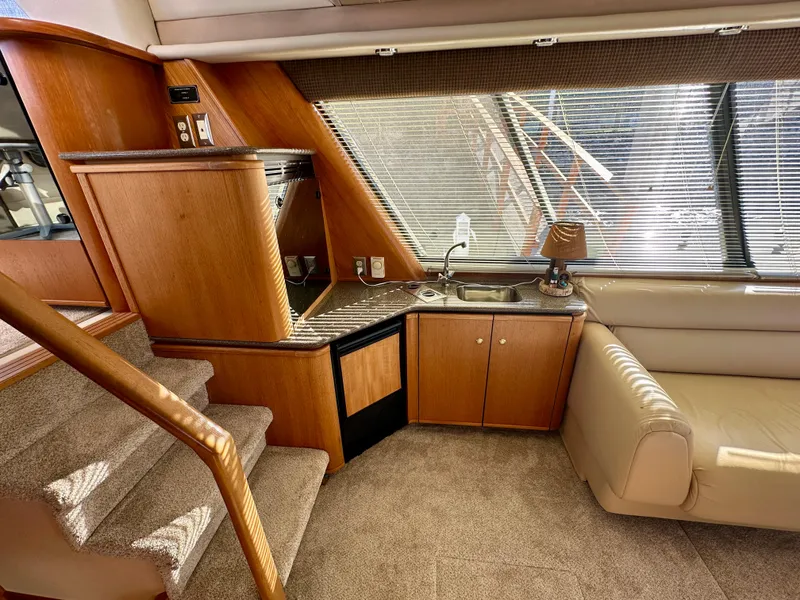 Slide: The Image of Interior of a 1999 Bayliner 4788 Pilot House Motoryacht with stairs, kitchenette, and sofa. - 36
