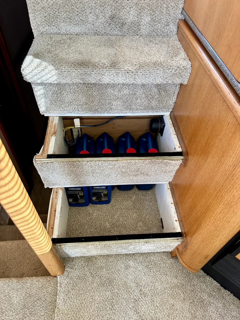 Slide: The Image of A carpeted stair landing with a drawer containing oil bottles. - 37