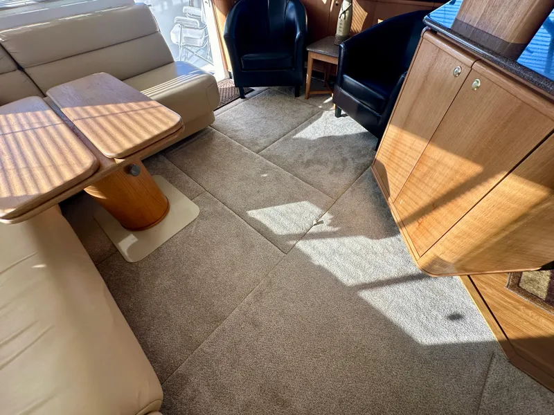 Slide: The Image of Interior of a 1999 Bayliner 4788 with beige sofas and wooden cabinetry. - 38