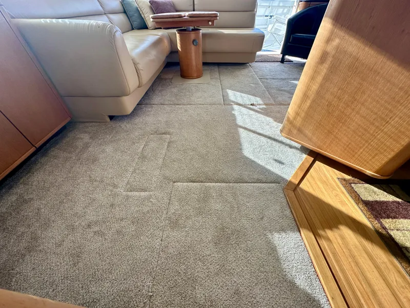 Slide: The Image of Interior of a 1999 Bayliner 4788 with beige sofa and carpeted floor. - 39