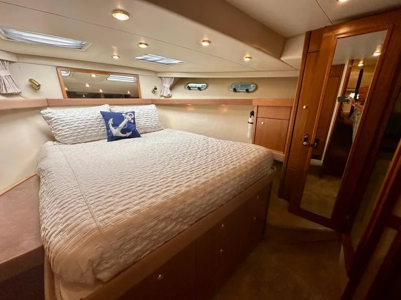 Slide: The Image of The image shows a cozy cabin with a large bed, wooden furnishings, and porthole windows. - 41