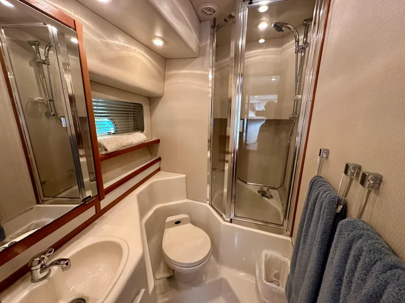 Slide: The Image of The image shows a yacht's elegant bathroom with a shower, sink, and toilet. - 44