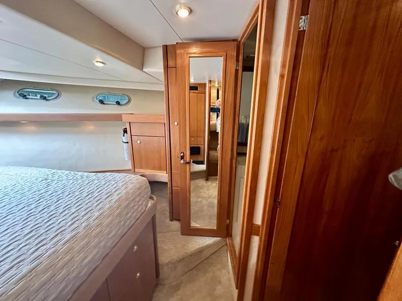 Slide: The Image of Interior of a 1999 Bayliner 4788 with wooden doors and a bed. - 43