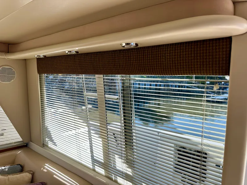 Slide: The Image of Interior view with large windows and blinds, offering a view of the water. - 23