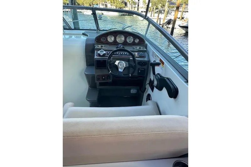 Slide: The Image of 2014 Rinker 260 Express Cruiser helm with steering wheel and instrument panel. - 10