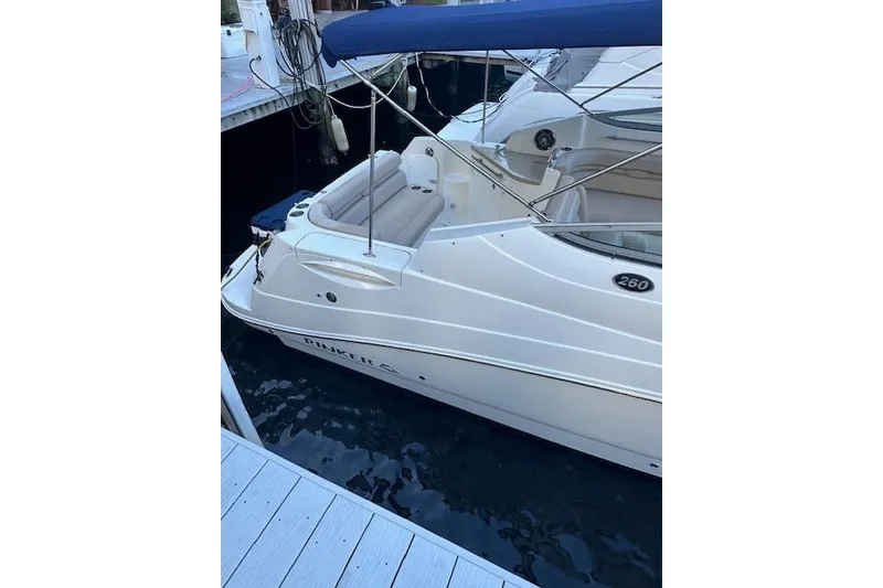 Slide: The Image of 2014 Rinker 260 Express Cruiser docked with blue canopy. - 9