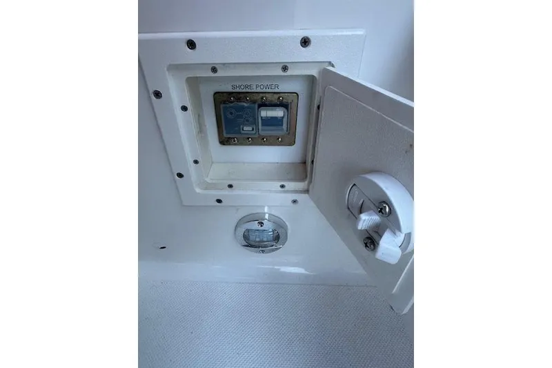 Slide: The Image of 2014 Rinker 260 Express Cruiser shore power connection panel. - 13