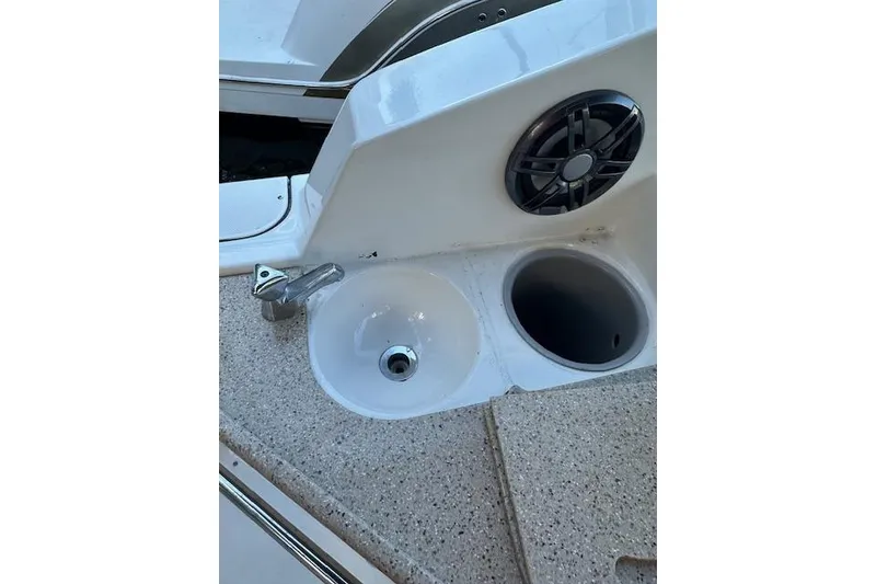 Slide: The Image of 2014 Rinker 260 Express Cruiser sink and speaker detail on deck. - 14