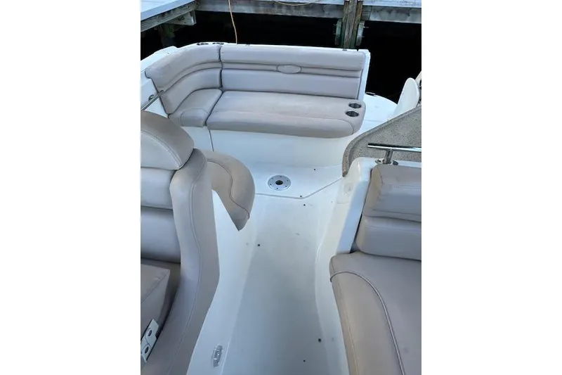 Slide: The Image of 2014 Rinker 260 Express Cruiser interior with beige seating and cup holders. - 17