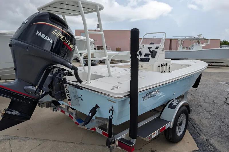 Slide: The Image of 2027 Hewes Redfisher 18 boat with Yamaha engine on trailer, parked outdoors. - 6