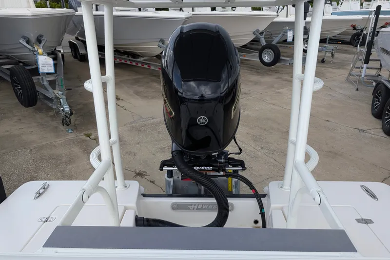 Slide: The Image of 2027 Hewes Redfisher 18 boat with Yamaha outboard motor in a marina setting. - 9