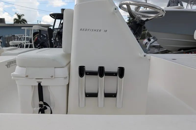 Slide: The Image of 2027 Hewes Redfisher 18 boat interior with rod holders and steering wheel. - 23